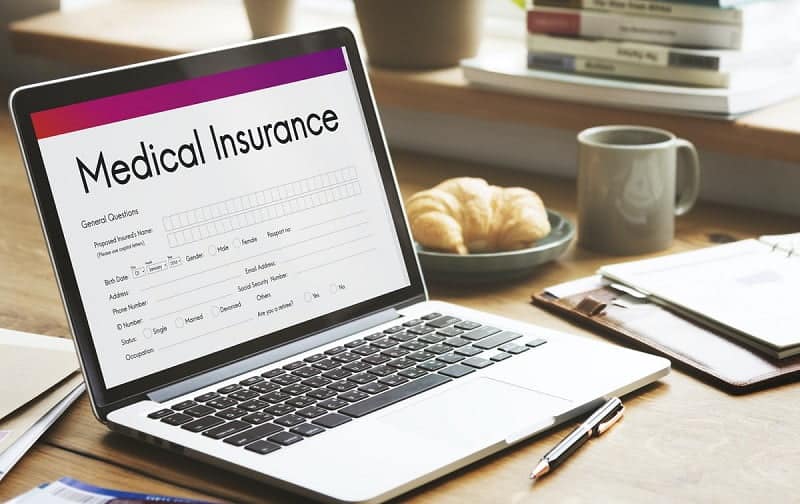 laptop with medical insurance form on the screen